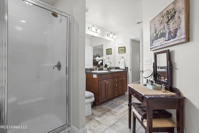 13703 Windwood Dr, Gulfport, MS 39503 - full bathroom with a stall shower, double vanity, tile patterned flooring, and toilet