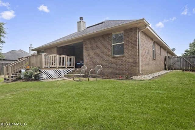 13703 Windwood Dr, Gulfport, MS 39503 - back of house featuring brick siding, a deck, a chimney, and a shingled roof