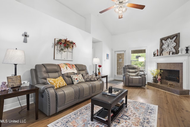 13703 Windwood Dr, Gulfport, MS 39503 - living area with a ceiling fan, wood finished floors, a fireplace, high vaulted ceiling, and baseboards