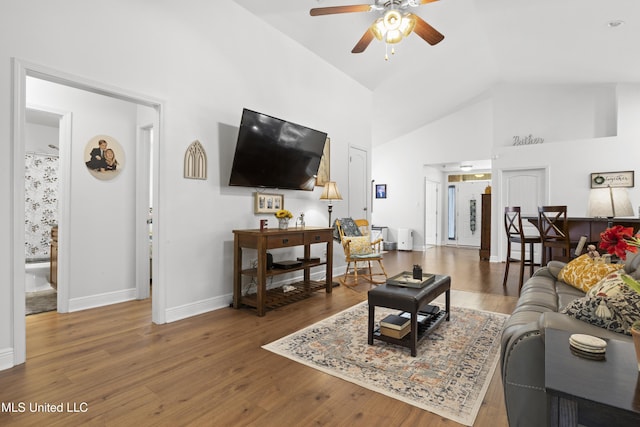 13703 Windwood Dr, Gulfport, MS 39503 - living room with ceiling fan, baseboards, high vaulted ceiling, and wood finished floors
