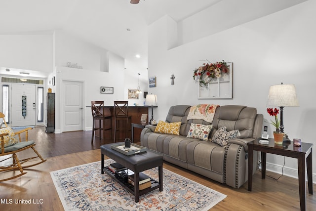 13703 Windwood Dr, Gulfport, MS 39503 - living room featuring high vaulted ceiling, wood finished floors, and baseboards