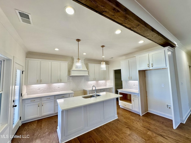 kitchen featuring dark hardwood / wood-style flooring, sink, pendant lighting, and white cabinets