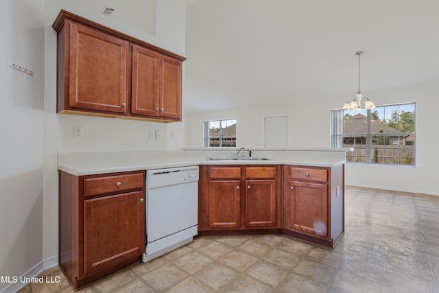 kitchen with kitchen peninsula, hanging light fixtures, an inviting chandelier, white dishwasher, and sink