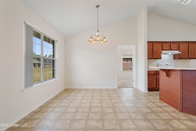 kitchen with a breakfast bar area, a chandelier, hanging light fixtures, and high vaulted ceiling