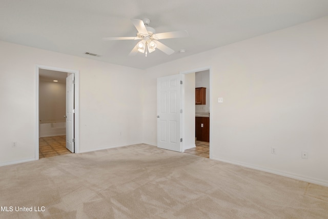 spare room with light carpet and ceiling fan