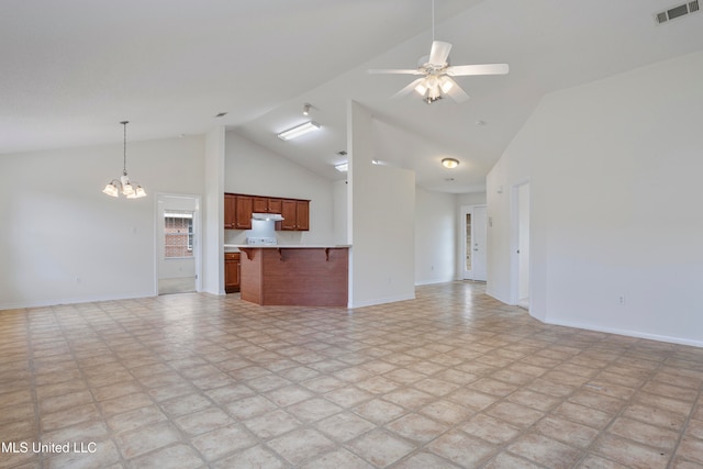 unfurnished living room featuring high vaulted ceiling and ceiling fan with notable chandelier