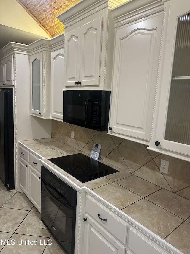 423 Grant Fox Dr, Brandon, MS 39047 - kitchen featuring black appliances, wood ceiling, vaulted ceiling, decorative backsplash, and tile counters
