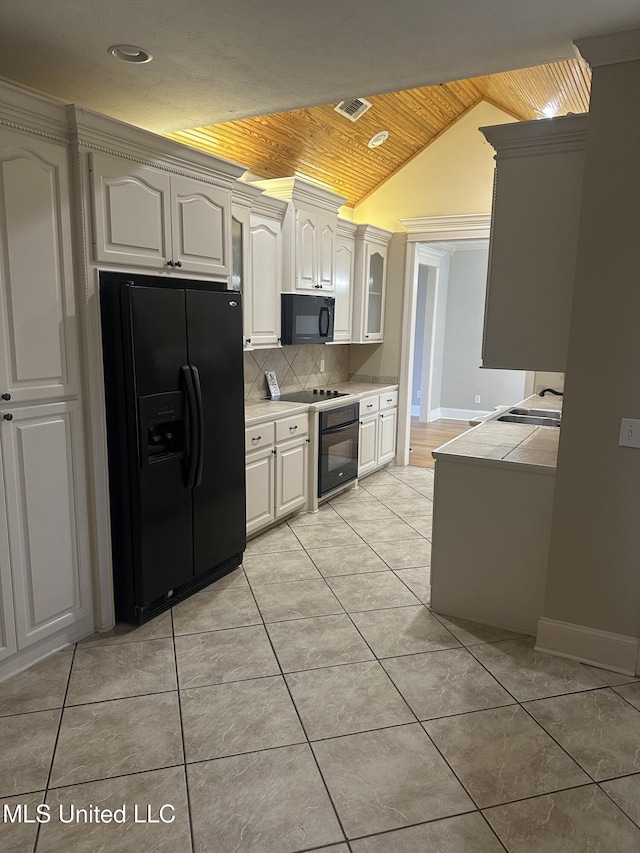 423 Grant Fox Dr, Brandon, MS 39047 - kitchen with black appliances, wood ceiling, vaulted ceiling, light countertops, and tasteful backsplash