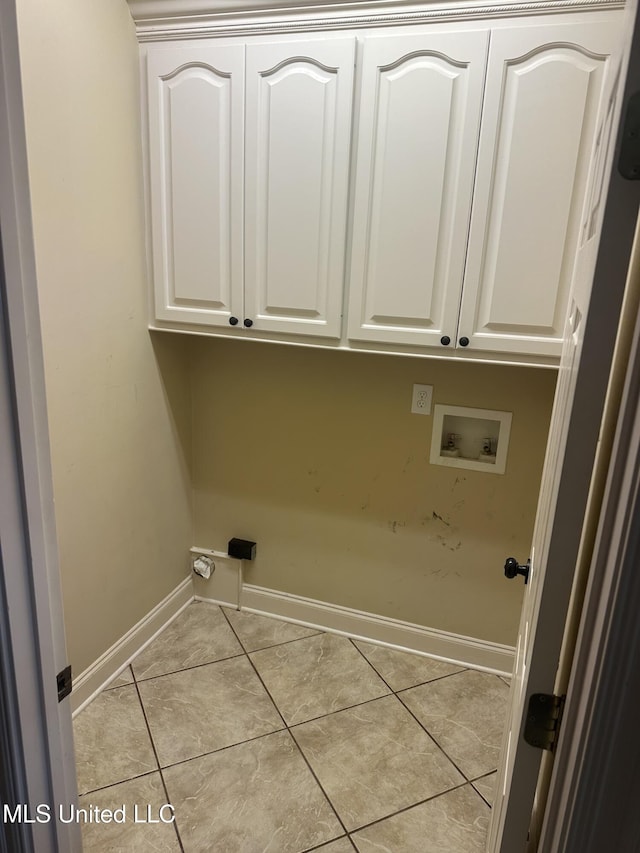423 Grant Fox Dr, Brandon, MS 39047 - laundry area with cabinet space, washer hookup, light tile patterned flooring, and baseboards
