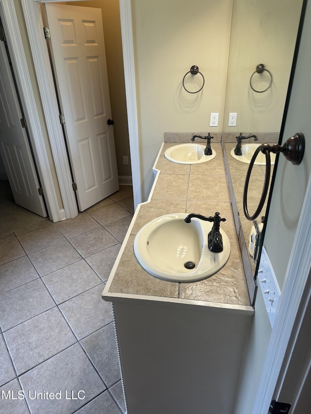 423 Grant Fox Dr, Brandon, MS 39047 - bathroom featuring tile patterned floors, double vanity, and baseboards