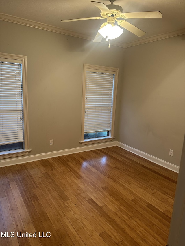 423 Grant Fox Dr, Brandon, MS 39047 - spare room featuring ornamental molding, wood finished floors, baseboards, a ceiling fan, and plenty of natural light