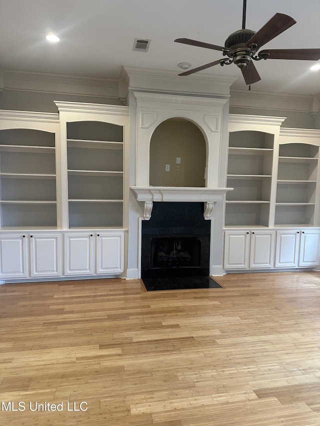 423 Grant Fox Dr, Brandon, MS 39047 - unfurnished living room with ornamental molding, ceiling fan, light wood-style floors, a fireplace with flush hearth, and built in features