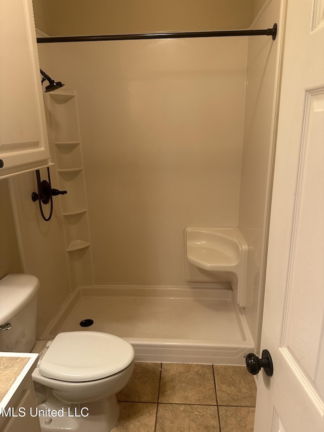 423 Grant Fox Dr, Brandon, MS 39047 - bathroom featuring toilet, tile patterned flooring, a shower stall, and vanity