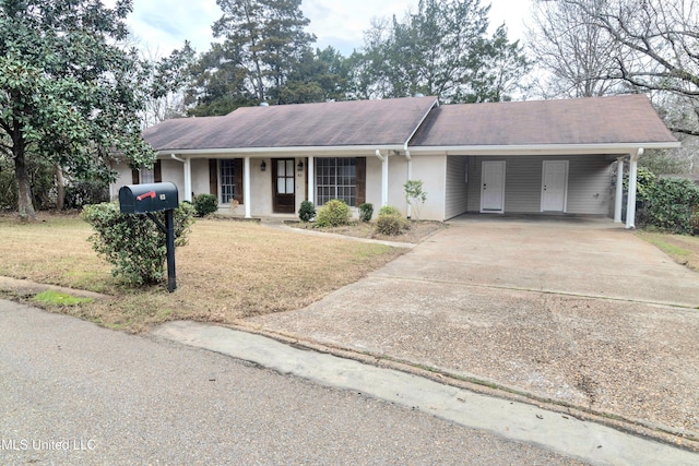 ranch-style home with a front yard and a carport