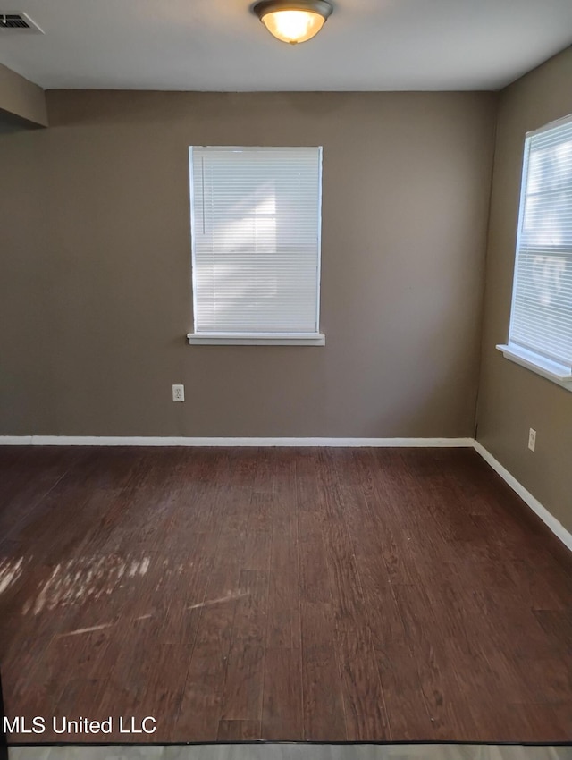 empty room with dark hardwood / wood-style floors