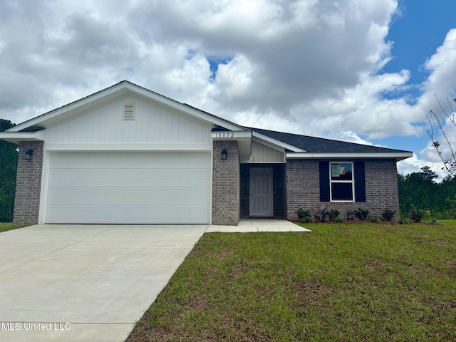 18052 Tiffany Renee Dr, Gulfport, MS 39503 - ranch-style house featuring brick siding, driveway, a garage, and a front yard