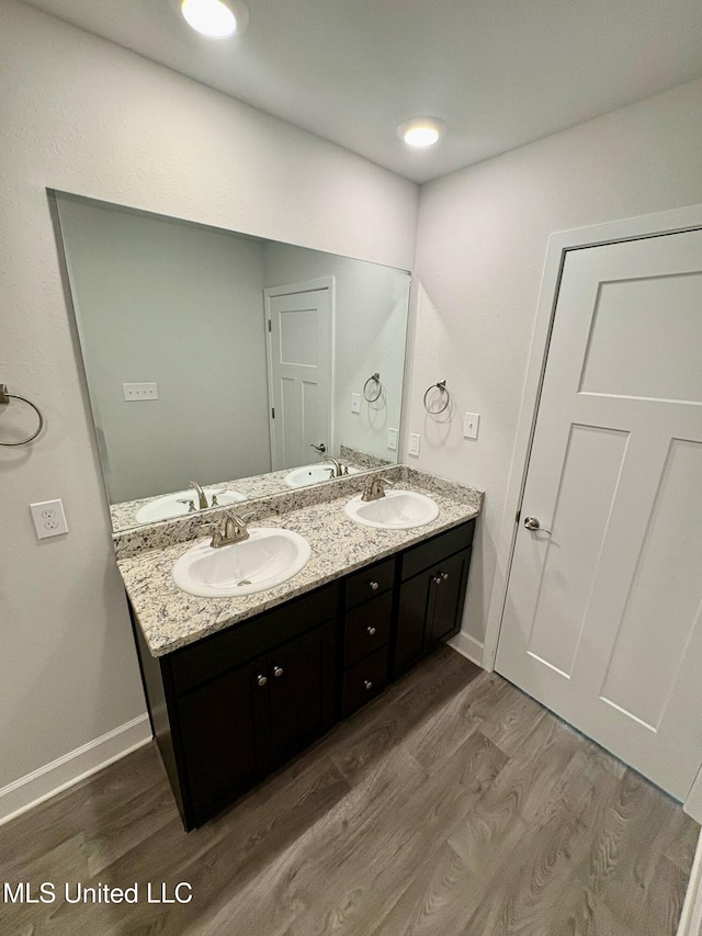 18052 Tiffany Renee Dr, Gulfport, MS 39503 - bathroom with wood finished floors, double vanity, and baseboards