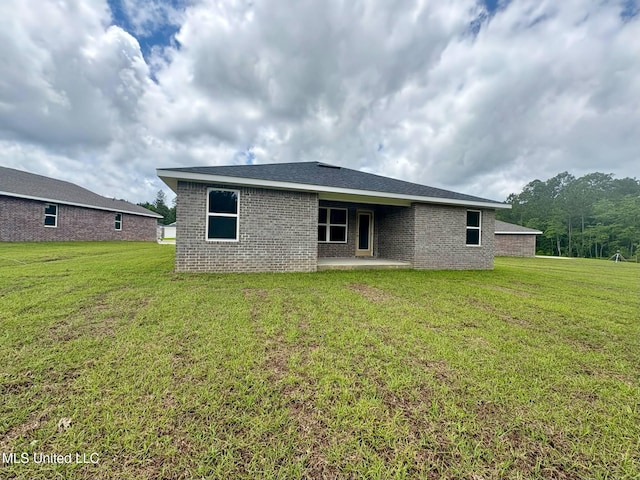18052 Tiffany Renee Dr, Gulfport, MS 39503 - rear view of property with a patio area, brick siding, and a yard