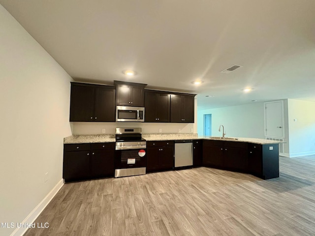 18052 Tiffany Renee Dr, Gulfport, MS 39503 - kitchen with appliances with stainless steel finishes, light wood finished floors, baseboards, a sink, and recessed lighting