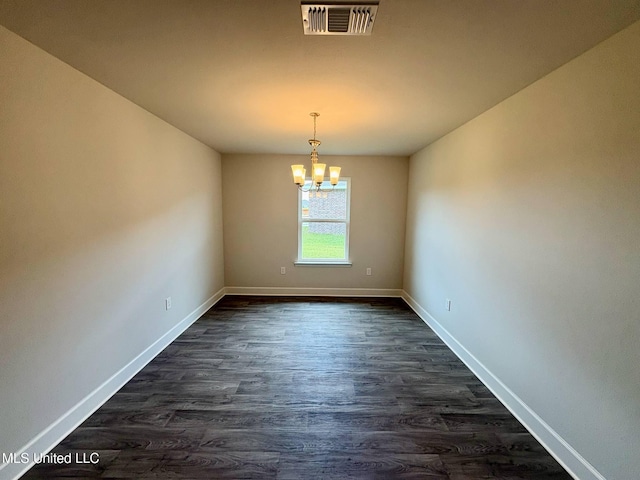 18052 Tiffany Renee Dr, Gulfport, MS 39503 - empty room featuring a chandelier, dark wood-type flooring, and baseboards