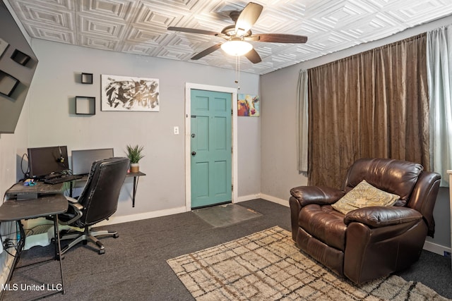 home office with baseboards, carpet flooring, ceiling fan, and an ornate ceiling