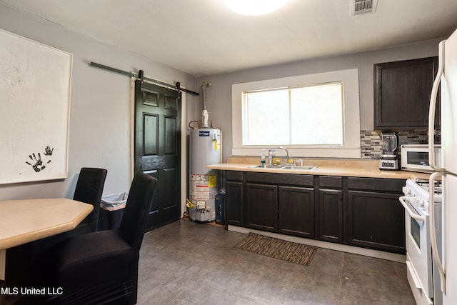 kitchen with a barn door, a sink, white appliances, water heater, and visible vents