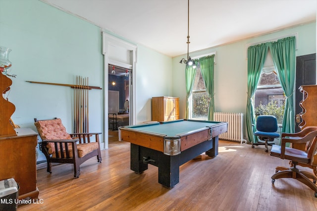 recreation room with radiator heating unit, billiards, and wood finished floors