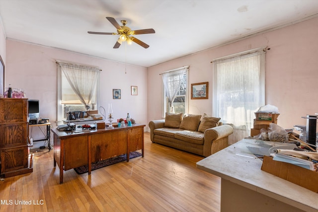 home office featuring light wood-style floors and ceiling fan