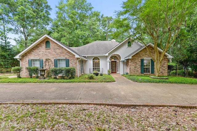 7635 Fairway Dr, Diamondhead, MS 39525 - ranch-style house with brick siding, stucco siding, and a chimney
