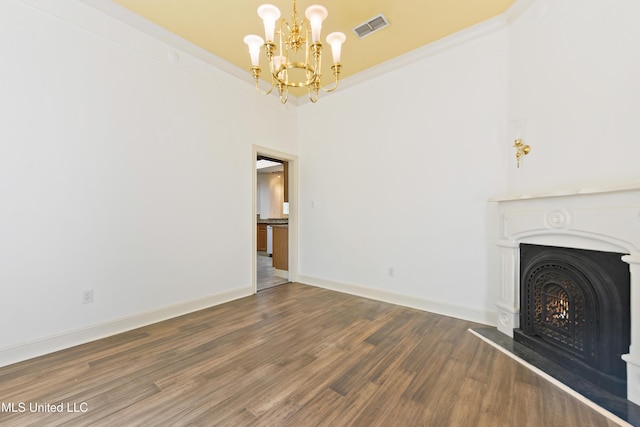 7635 Fairway Dr, Diamondhead, MS 39525 - unfurnished living room featuring a chandelier, wood finished floors, a lit fireplace, and baseboards