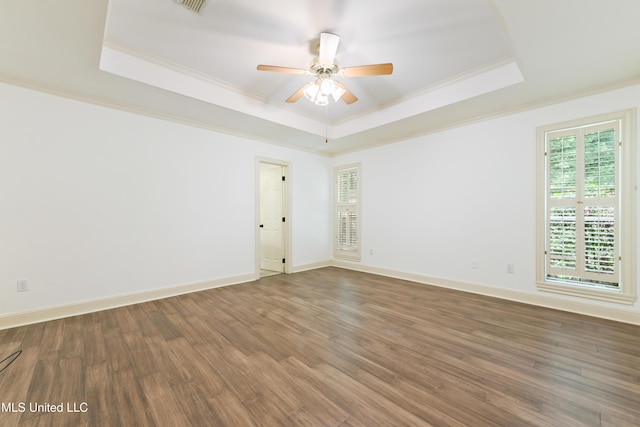 7635 Fairway Dr, Diamondhead, MS 39525 - spare room featuring a raised ceiling, ornamental molding, wood finished floors, a ceiling fan, and baseboards