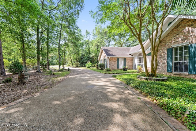7635 Fairway Dr, Diamondhead, MS 39525 - view of front facade with brick siding and driveway