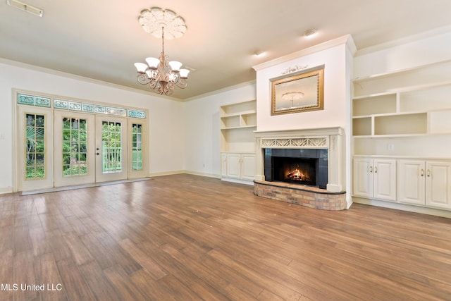 7635 Fairway Dr, Diamondhead, MS 39525 - unfurnished living room with a chandelier, wood finished floors, baseboards, and a fireplace