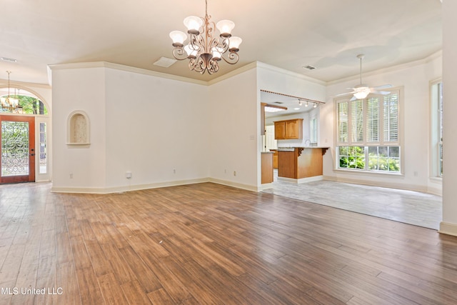 7635 Fairway Dr, Diamondhead, MS 39525 - unfurnished living room with a chandelier, plenty of natural light, ornamental molding, light wood-style flooring, and baseboards