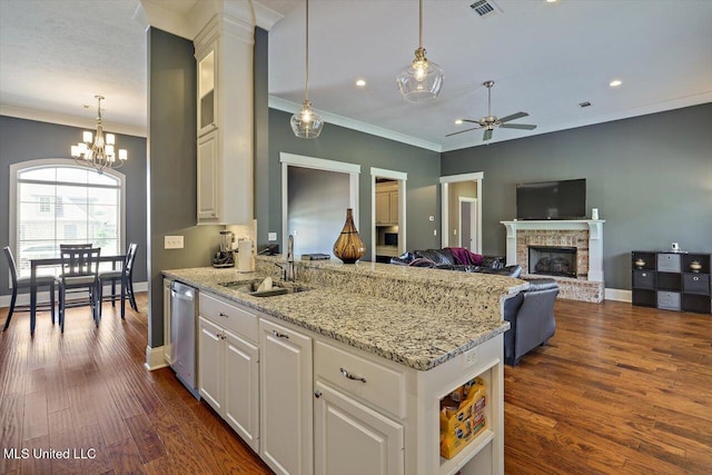 244 Hidden Hills Pkwy, Brandon, MS 39047 - kitchen with ornamental molding, a ceiling fan, a peninsula, a fireplace, and light stone counters