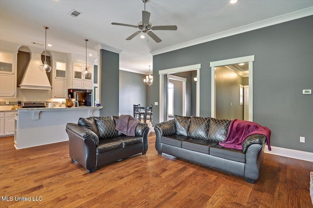 244 Hidden Hills Pkwy, Brandon, MS 39047 - living room featuring crown molding, a ceiling fan, wood finished floors, recessed lighting, and a chandelier