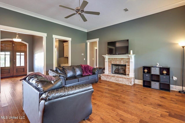 244 Hidden Hills Pkwy, Brandon, MS 39047 - living area featuring crown molding, wood finished floors, a ceiling fan, a fireplace, and french doors
