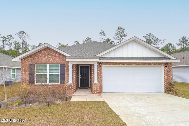 view of front of home featuring a front yard, a garage, and cooling unit