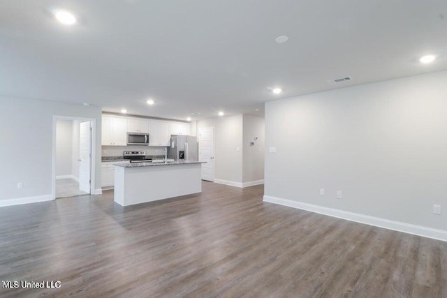 unfurnished living room featuring dark wood-type flooring