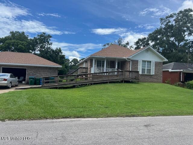 ranch-style home featuring a front lawn, covered porch, and a garage