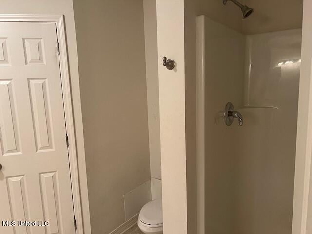 bathroom with toilet and walk in shower