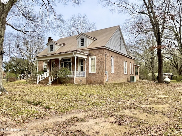 view of front of property with covered porch and central AC unit