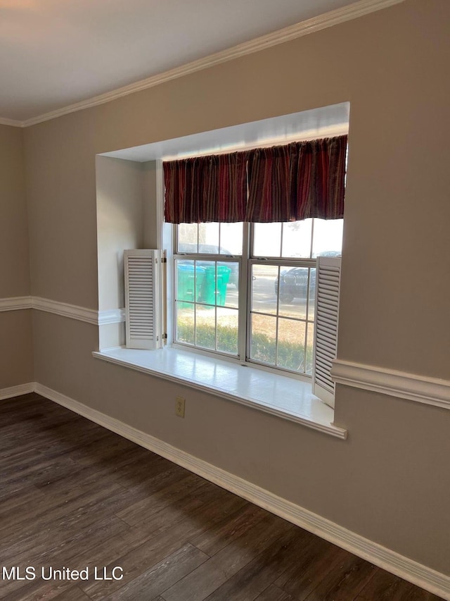 spare room with dark wood-type flooring and crown molding