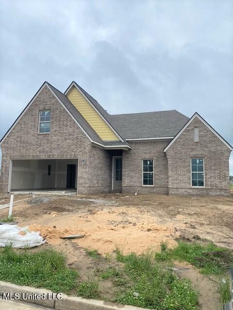 3128 Leatherman Dr, Lake Cormorant, MS 38641 - view of front of house with brick siding, a garage, and a shingled roof
