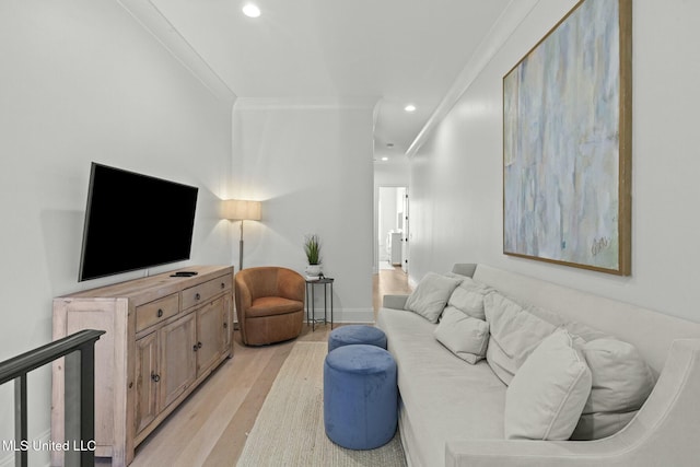 living area with recessed lighting, light wood-type flooring, baseboards, and ornamental molding