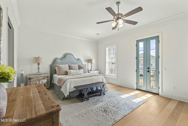 bedroom featuring visible vents, ornamental molding, light wood finished floors, baseboards, and access to exterior