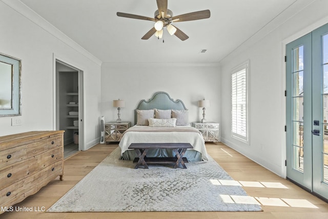 bedroom featuring access to exterior, light wood-style flooring, baseboards, and ornamental molding