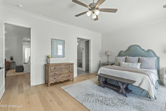 bedroom featuring visible vents, baseboards, light wood-style flooring, and ornamental molding