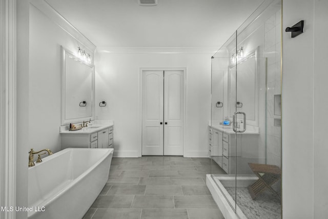 bathroom featuring vanity, baseboards, a soaking tub, a stall shower, and crown molding