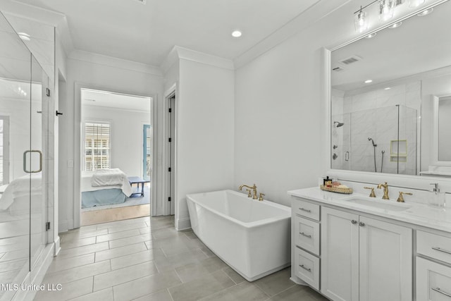 ensuite bathroom featuring visible vents, a shower stall, crown molding, a freestanding bath, and vanity